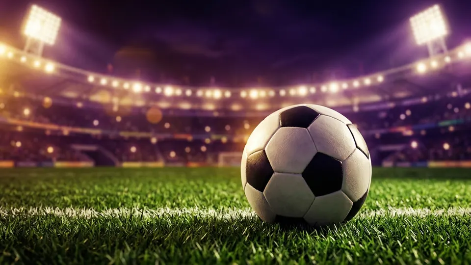 Pelota de fútbol en un estadio iluminado de noche para apuestas deportivas
